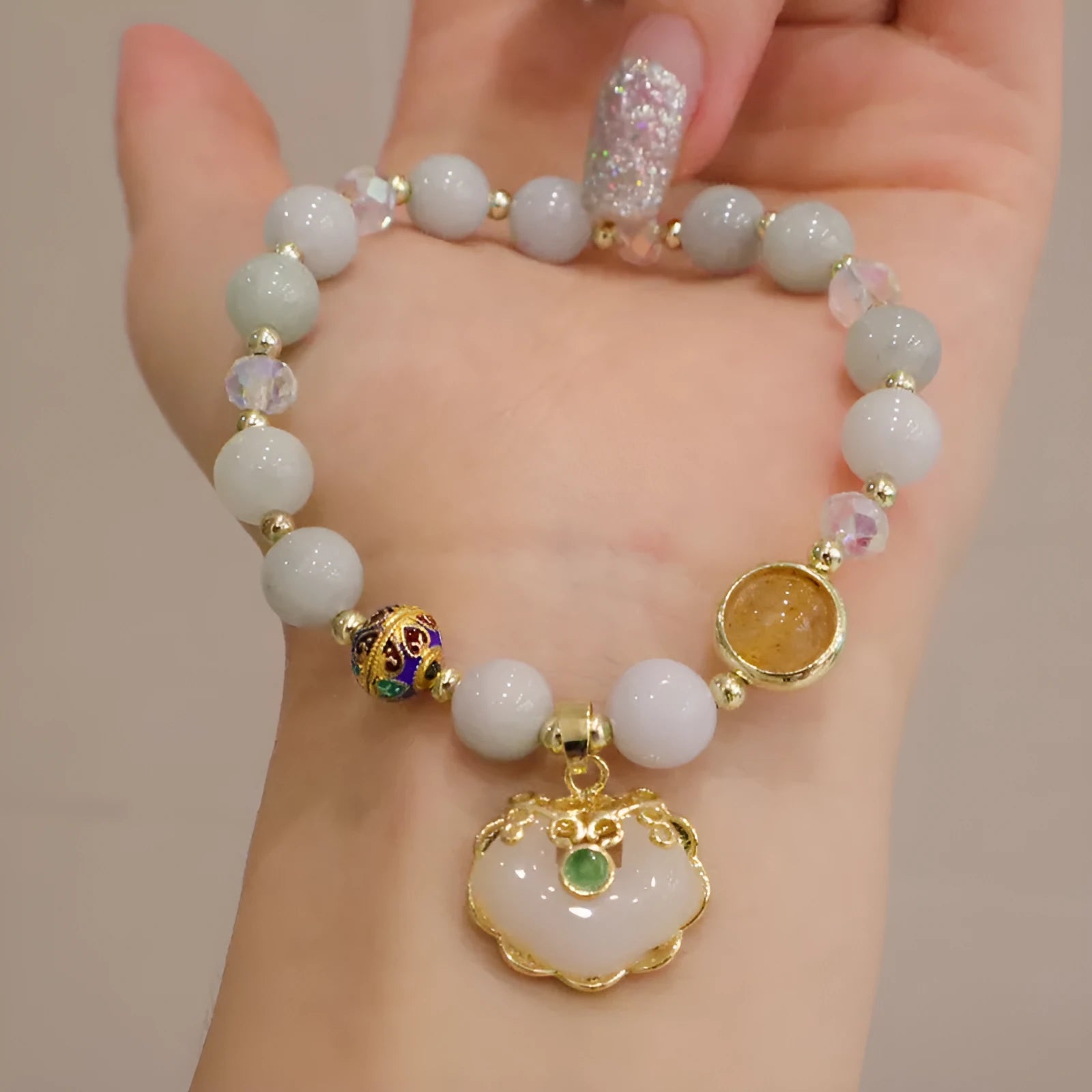 Women's bracelet with strawberry quartz and gray jade stones and ethnic metal decorations