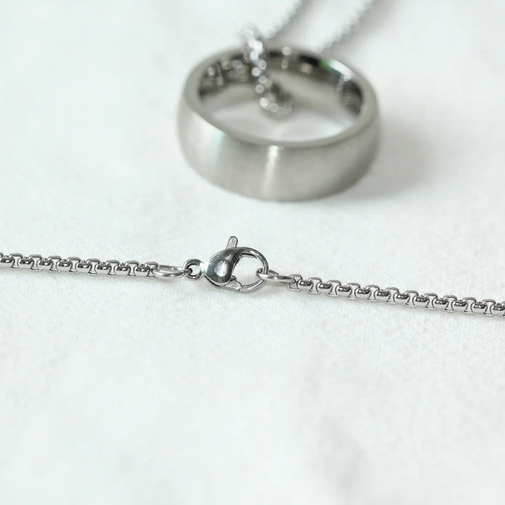 Men's silver pearl chain circle pendant necklace with stainless steel chain and titanium steel pendant on neutral background