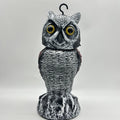 Artificial owl bird scarer decoy with shaking head motion in outdoor setting