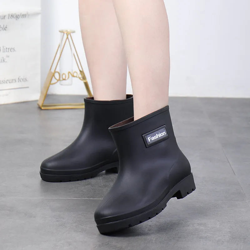 Women's mid-calf PVC rain boots in black with low heel design