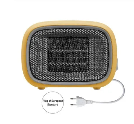 Compact green mini ceramic heater with metal mesh front on a wooden desk