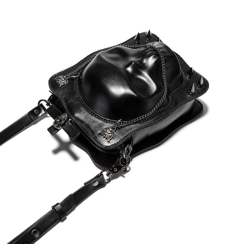 Black Gothic skull crossbody bag with embossed design, square shape, and chain detailing