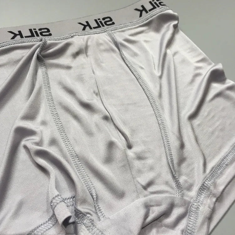 Men's loose-fitting silk shorts in navy blue on a mid-waist.
