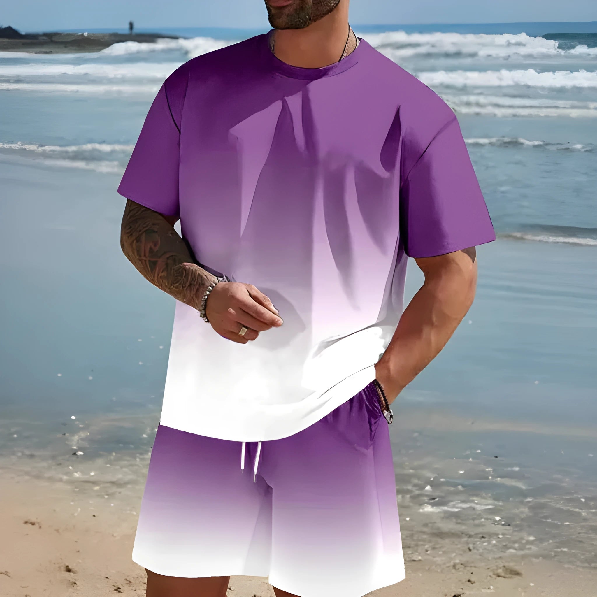 Man wearing a loose blue short-sleeved t-shirt and matching shorts from a summer leisure set.
