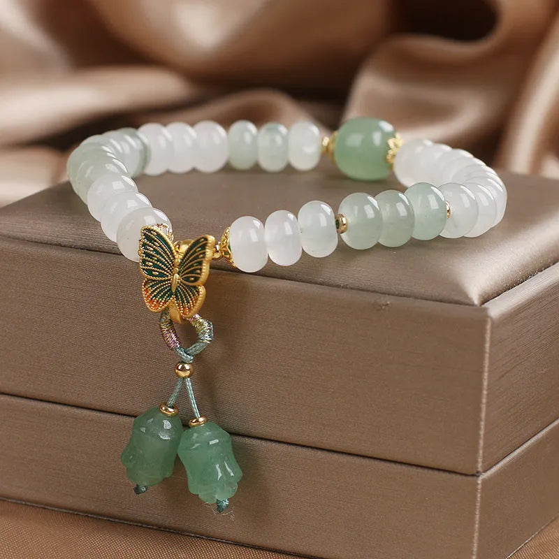 Green crystal Tian Shan Cui abacus bead bracelet with a retro butterfly tassel and pearl detailing.