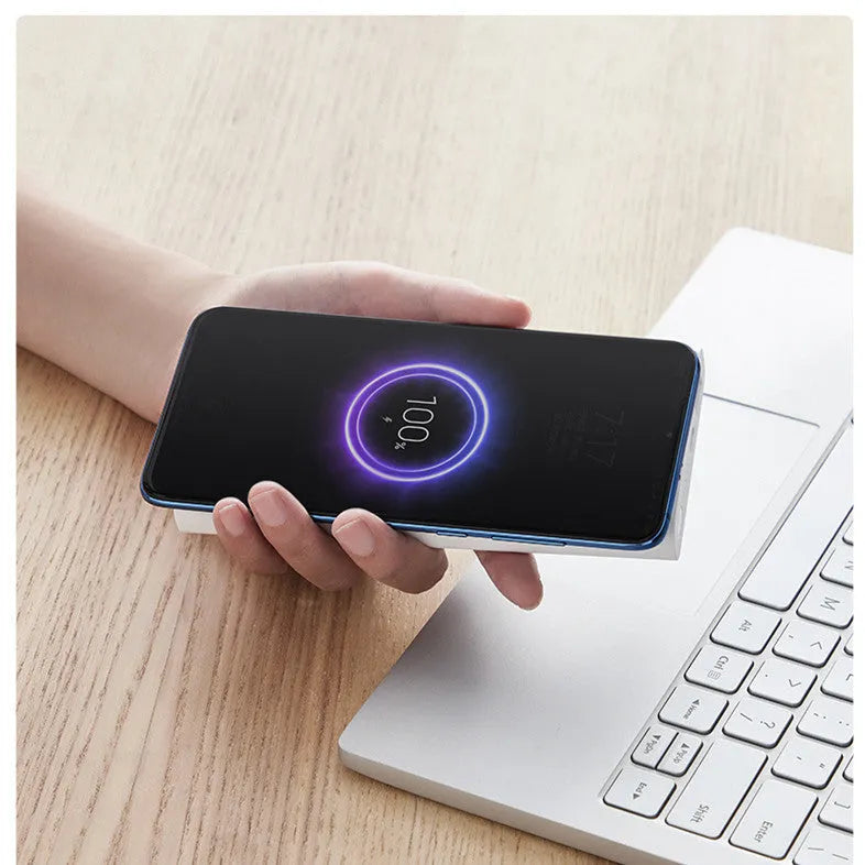 Black and white 10000mAh capacity power bank with wireless charging and fast charge support.