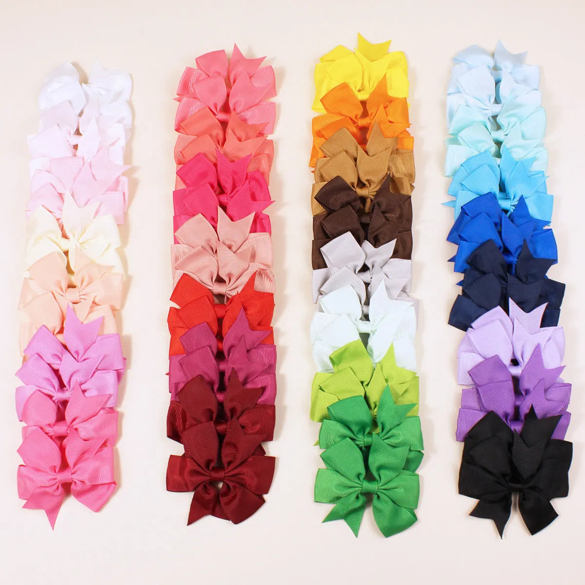 Assortment of multicoloured 3 inch grosgrain ribbon pinwheel hair bows with alligator clips for toddlers.