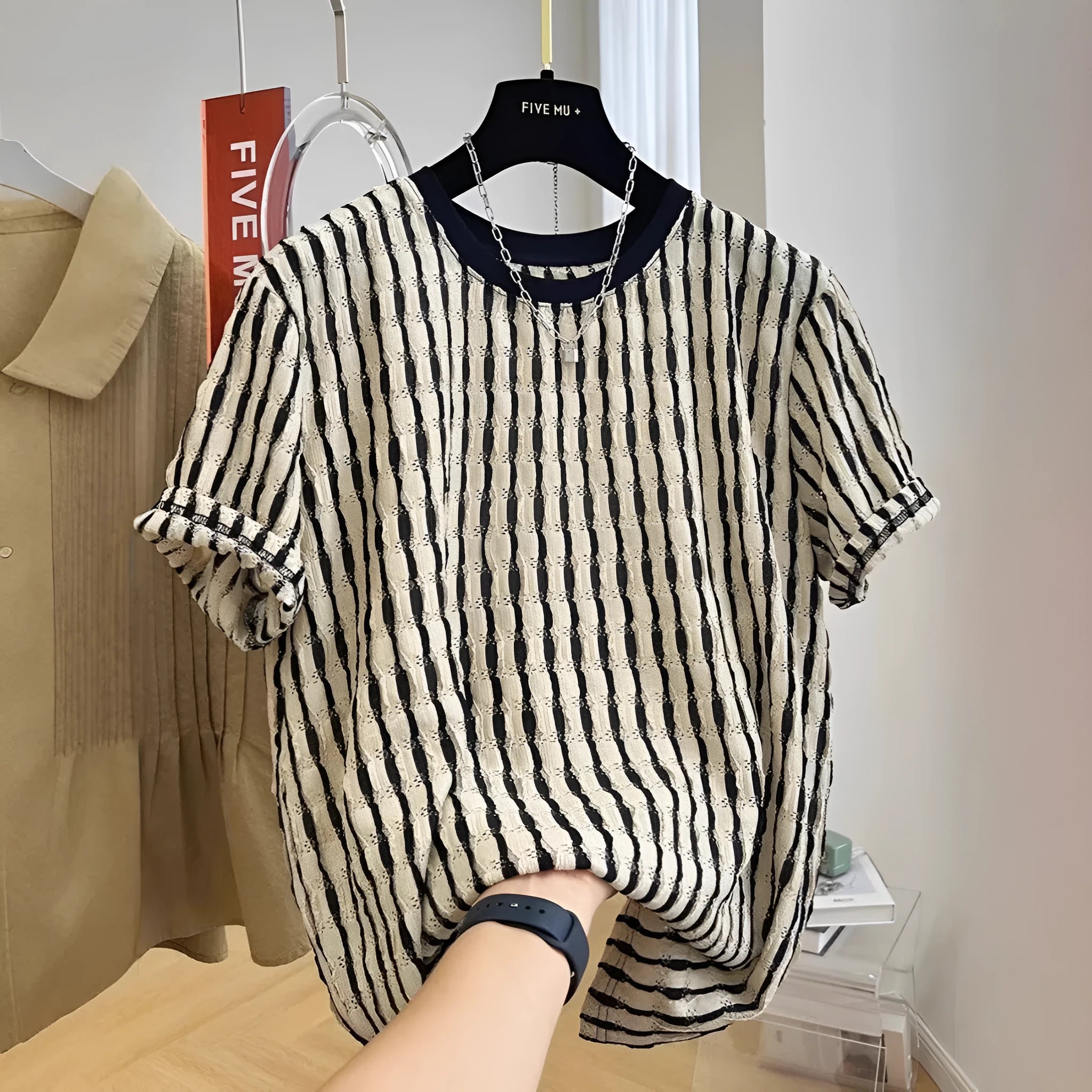 Black striped men's pullover shirt with loose fit and short sleeves made from linen silk blend fabric