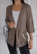 Women's army green waffle knit cardigan coat with nine-quarter sleeves and pockets.