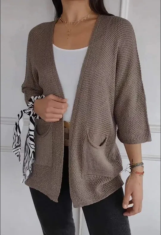 Women's army green waffle knit cardigan coat with nine-quarter sleeves and pockets.