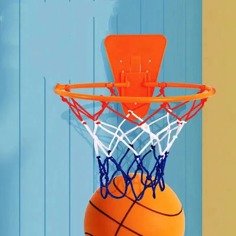 Assortment of bright coloured silent foam basketballs with a basketball frame on a neutral background