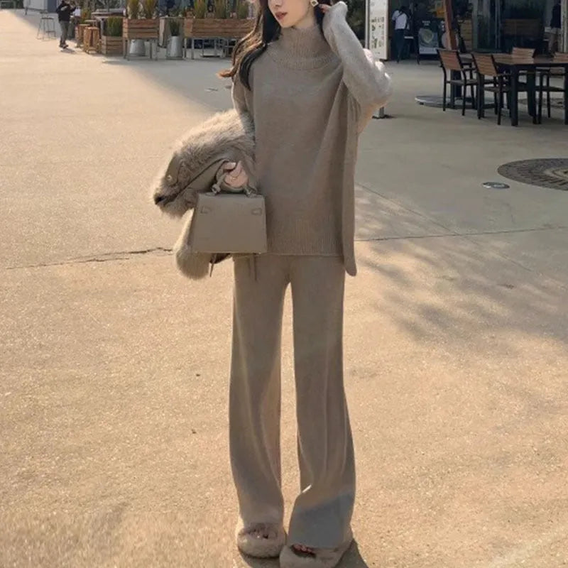 Women's casual two-piece set showing sweater and wide leg trousers in solid colour with thread detail