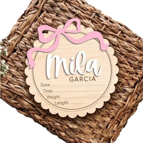 Customised square wooden baby room ornament with a personal name, shown in two size options.