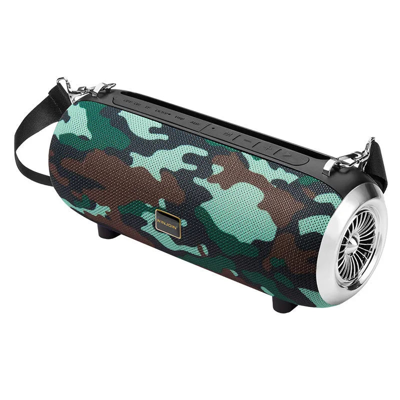 Square fabric portable Bluetooth speaker with FM antenna, shoulder strap, and phone stand groove.