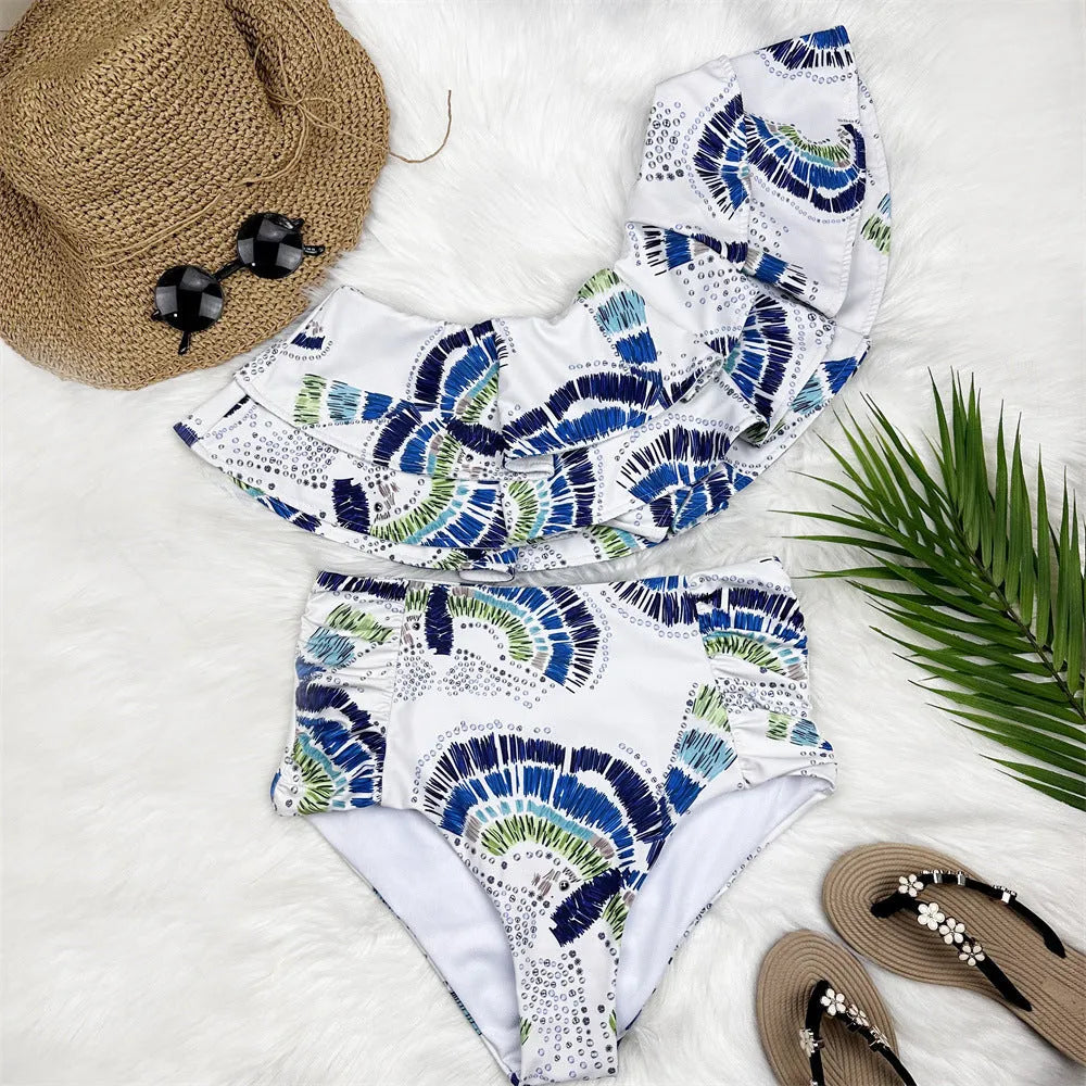 White women's swimsuit with one-shoulder design featuring large lotus leaf detailing and split hem