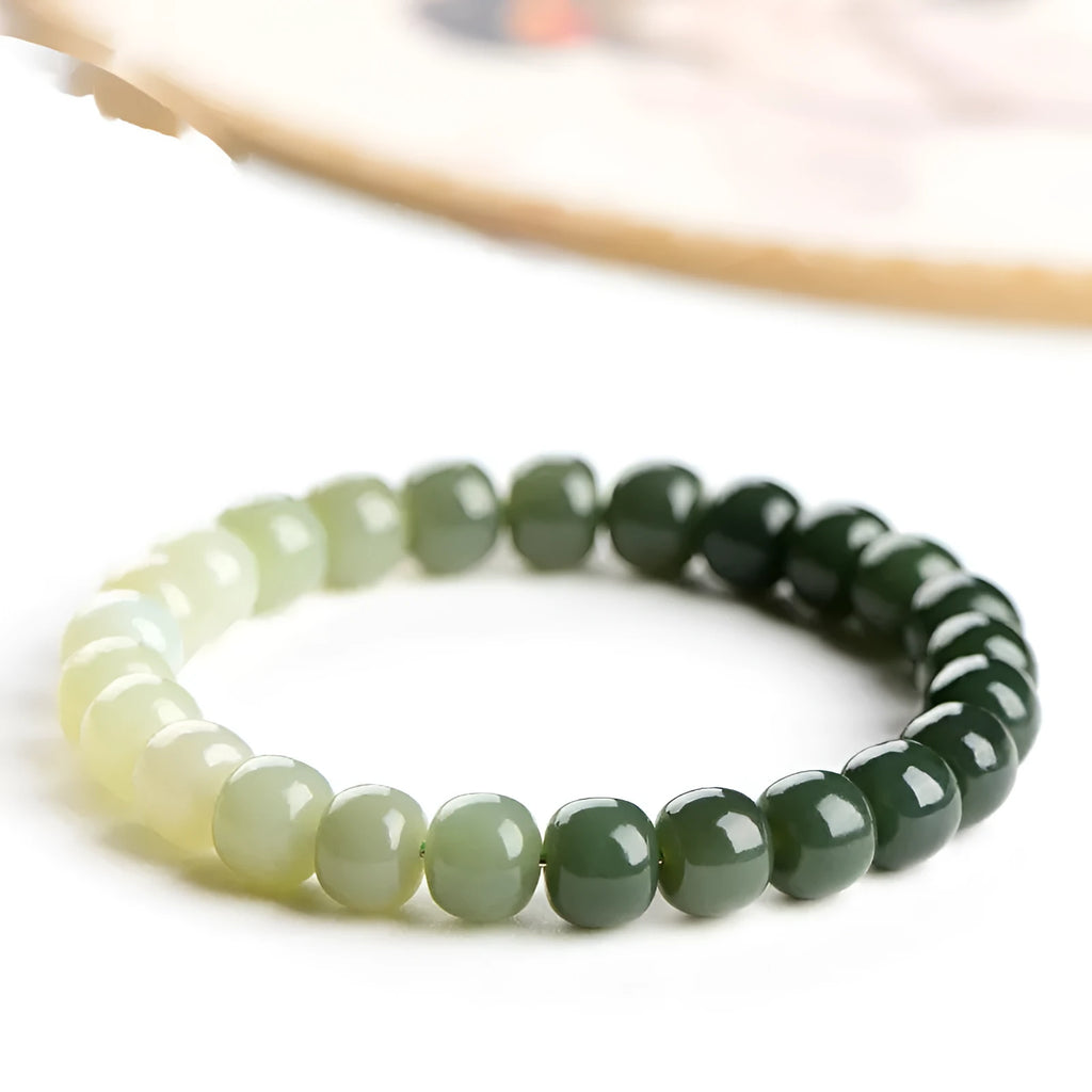 Hetian jade bracelet with clear water gradient beads on wrist.