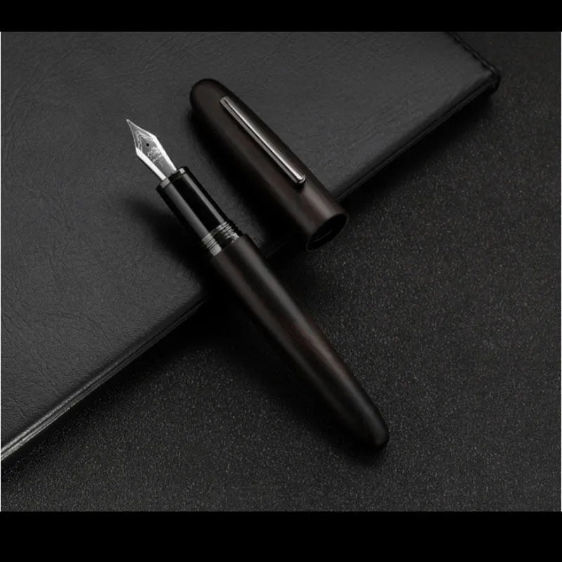 Wooden fountain pen with rotating cap shown in various wood finishes including rosewood and ebony.