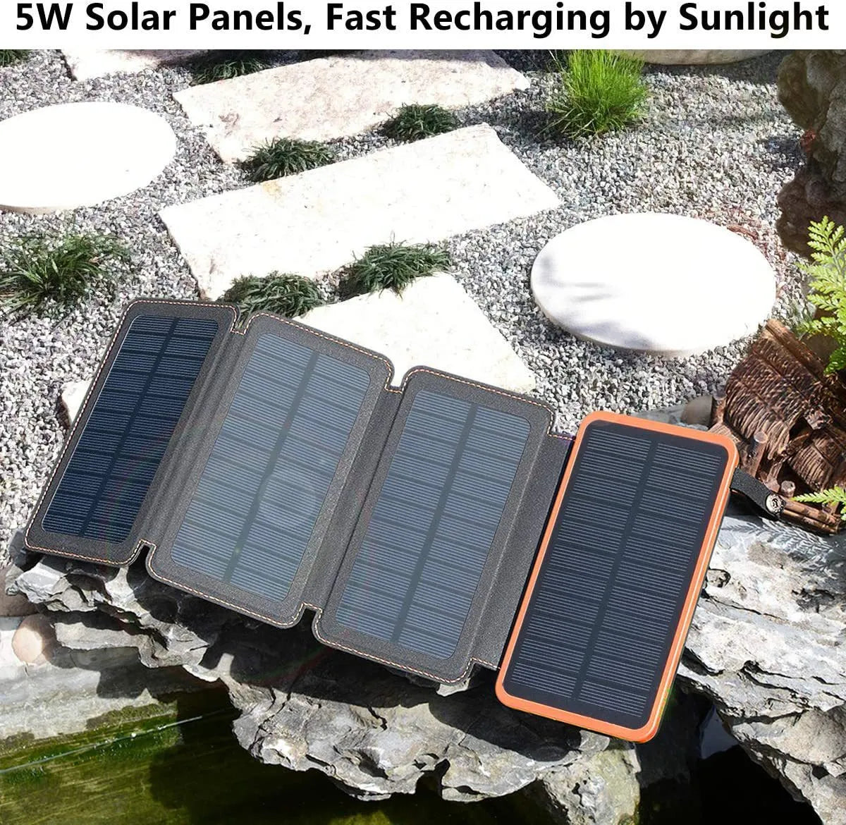 Black solar power bank with a solar panel, showing its USB ports and LED light, placed outdoors on a rock.