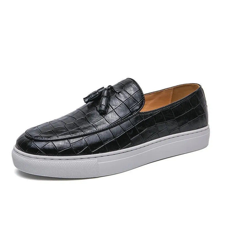 Men's plus size black slip-on sneakers with tassel detail and round toe on a rubber sole.