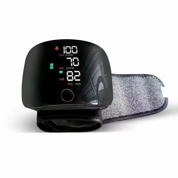 Black wrist blood pressure monitor with USB rechargeable port and multi-language voice function.