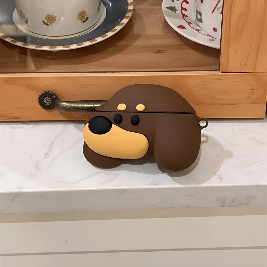 Brown puppy silicone earphone case on AirPods charging case with embossed cartoon design