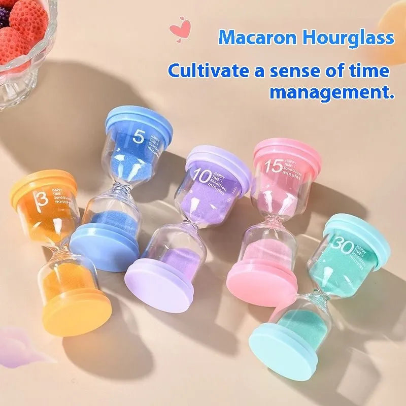 Handmade glass sand timer hourglass in blue on a plain background.