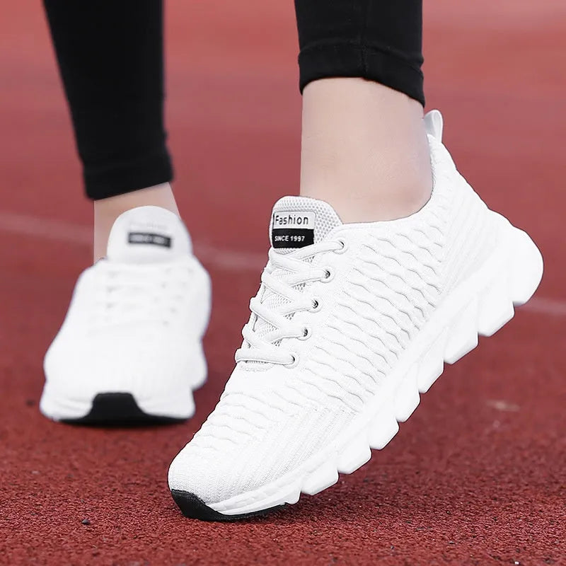 Women's black running shoe with fly weave upper and textured wear-resistant outsole.