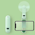 Green folding mini USB rechargeable personal desk fan with plastic blades.