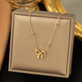 Gold titanium steel bow necklace with cross chain style for women
