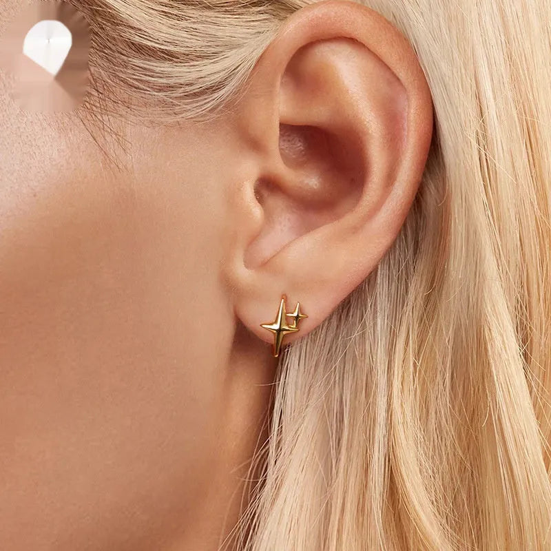 Minimalist star sterling silver ear clips with oxidation finish and XINGX design element