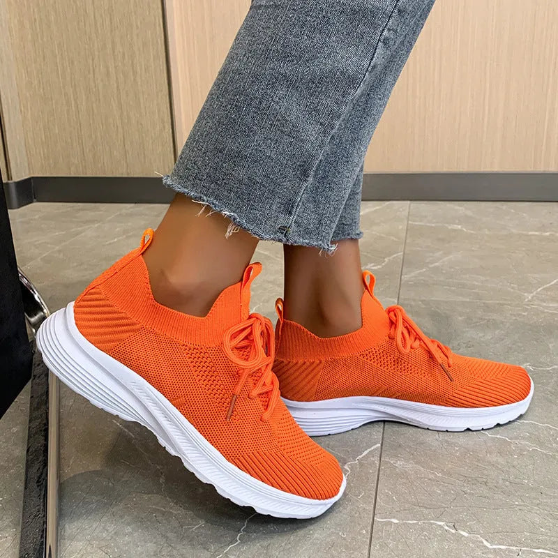 Women's low-top running shoes in Creamy White with mesh detailing and a flat rubber sole.
