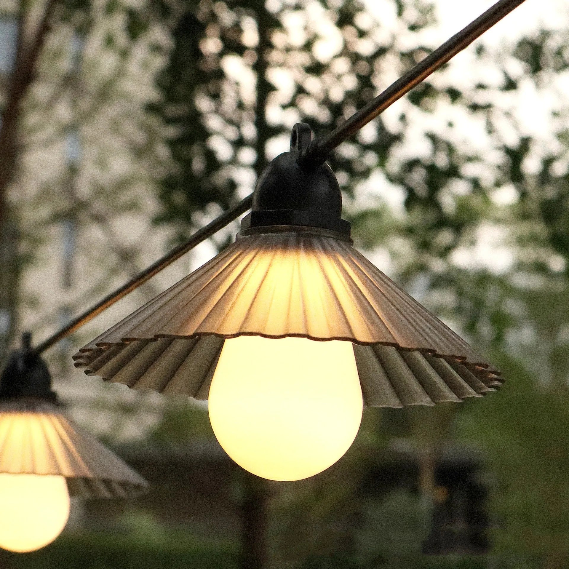 Outdoor LED string lights with flower-shaped bulbs showing warm white and coloured lighting options