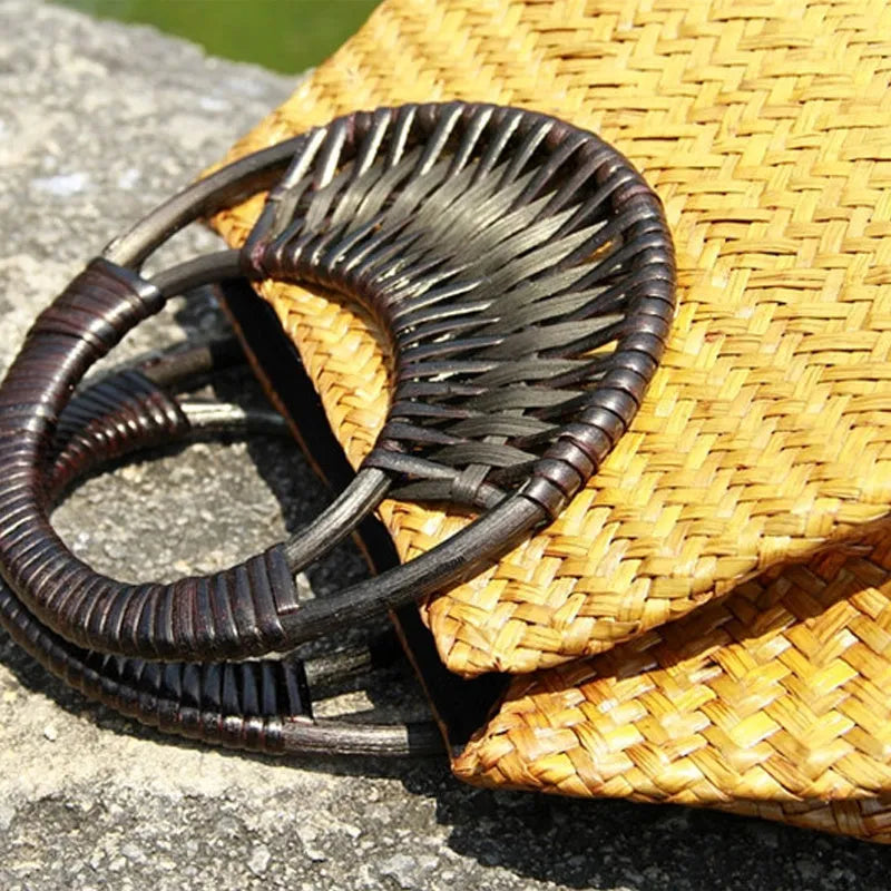Handwoven rattan straw bag for women with wooden handle, cotton lining, and zipper closure in khaki colour