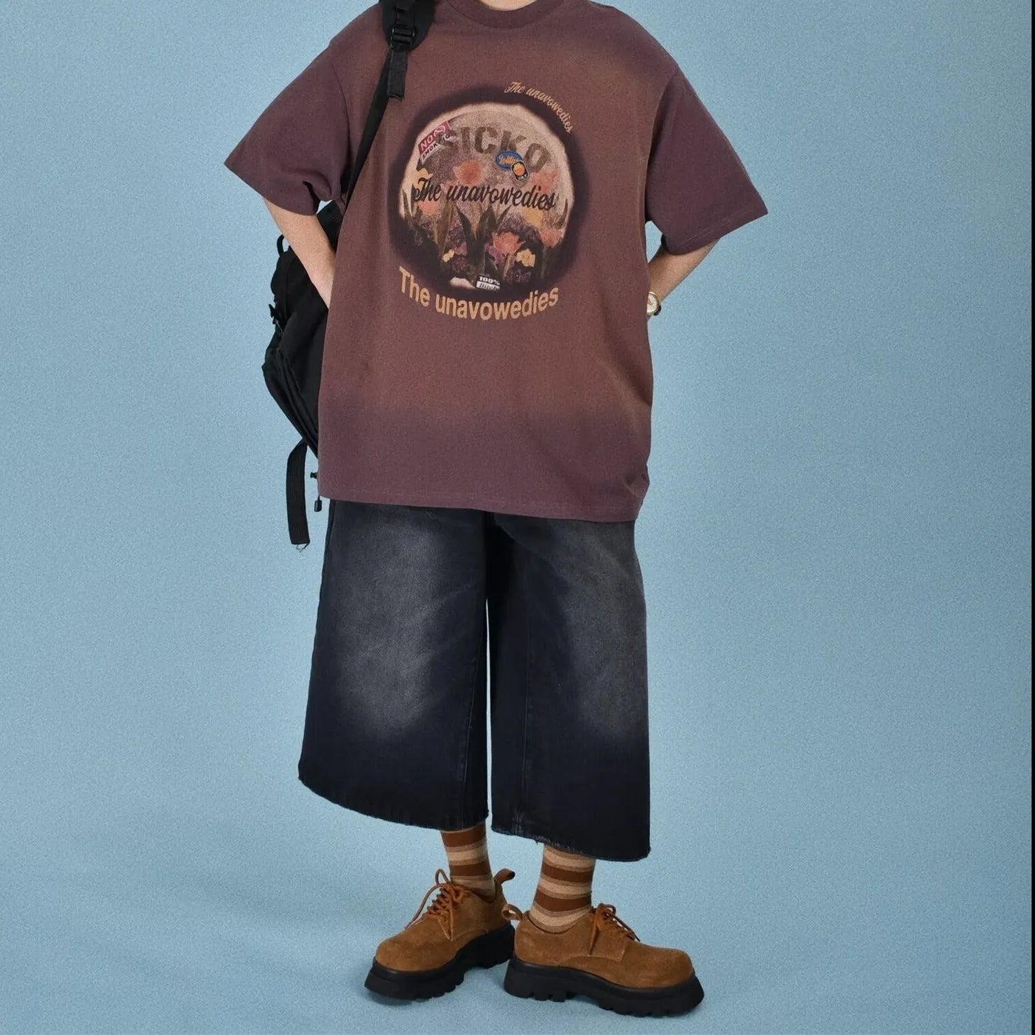 Men's loose straight-leg denim shorts in blue on a plain background