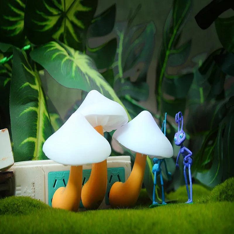 Mushroom-shaped LED night light with light sensor, warm yellow glow, plugging into a wall socket