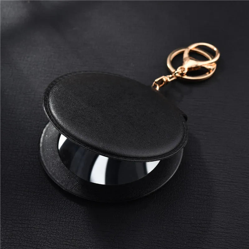 Compact round ladies leather makeup mirror with 8cm diameter glass surface and golden buckle
