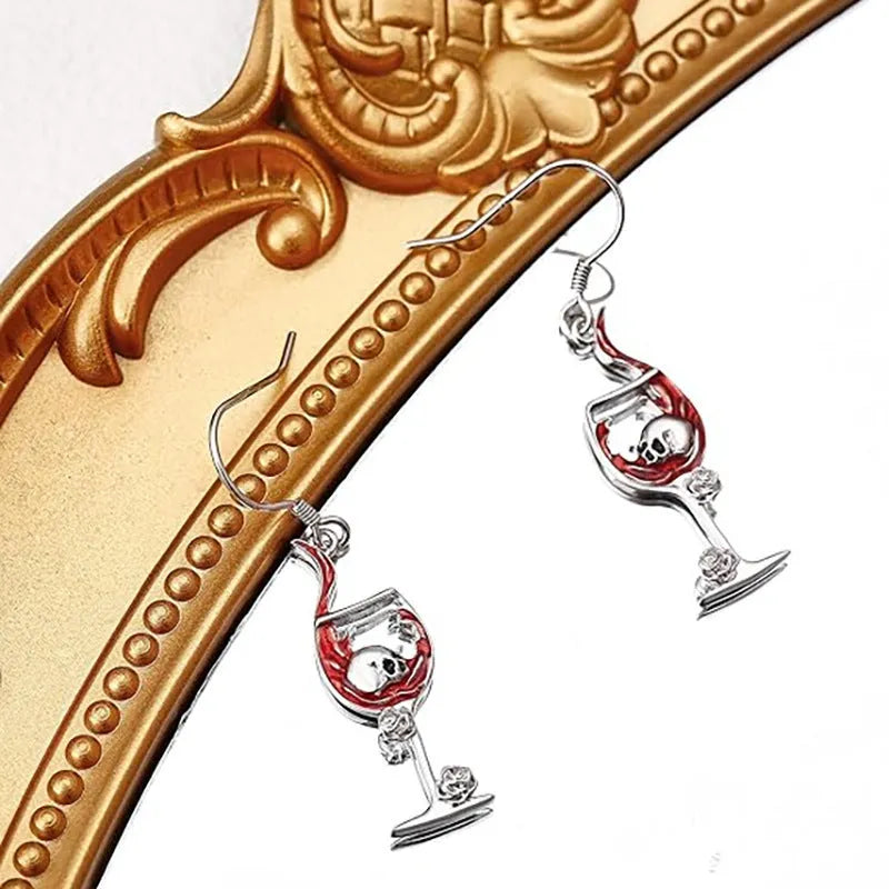 Close-up of a pair of geometric zinc alloy earrings with a skull and wine glass design and electroplated finish.