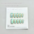 Electroplated Cat's Eye artificial nail art set in short ladder lengths XS, S, and M on display.