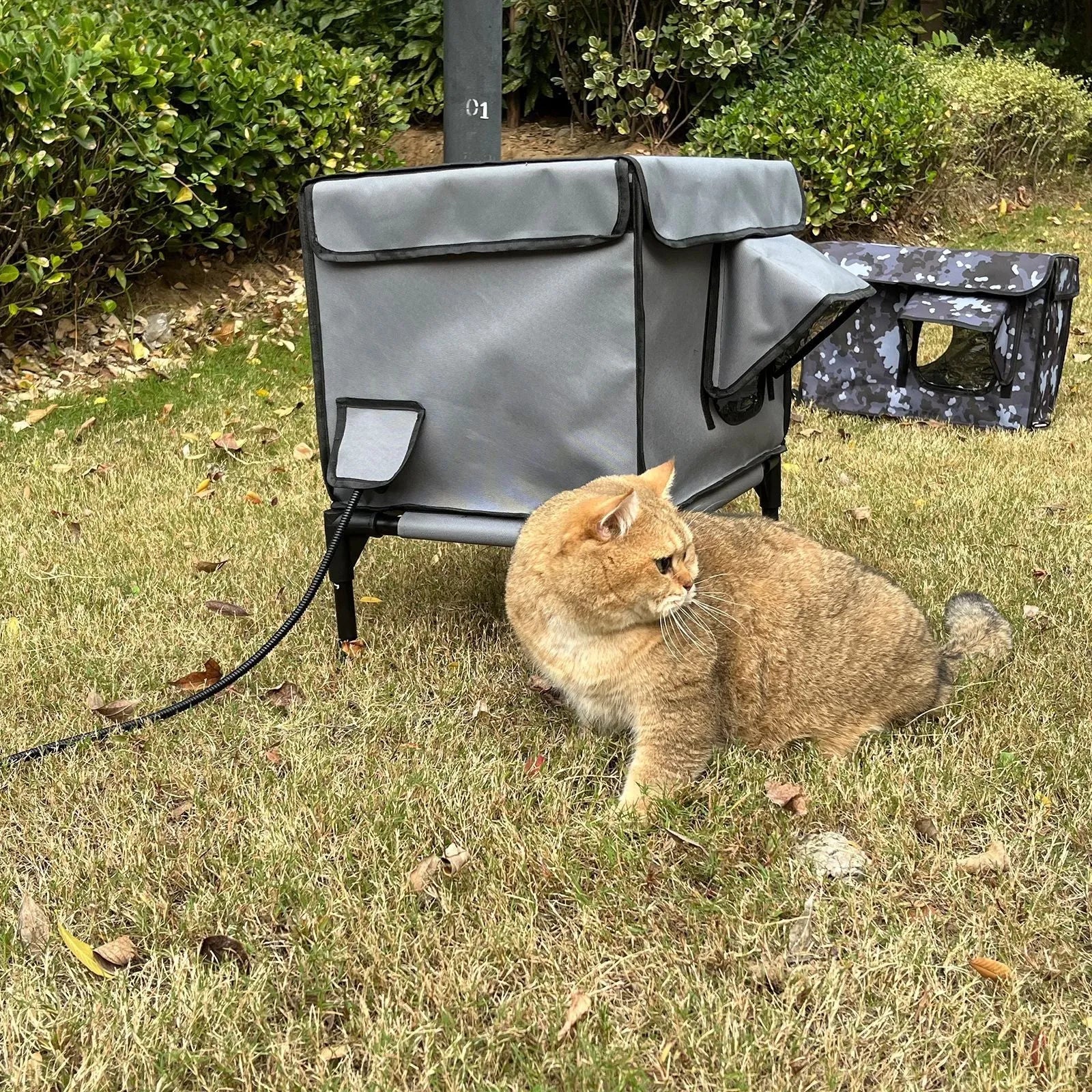 Outdoor heating insulation foldable cat nest with thermo sensitive switch in black, size M, on a floor