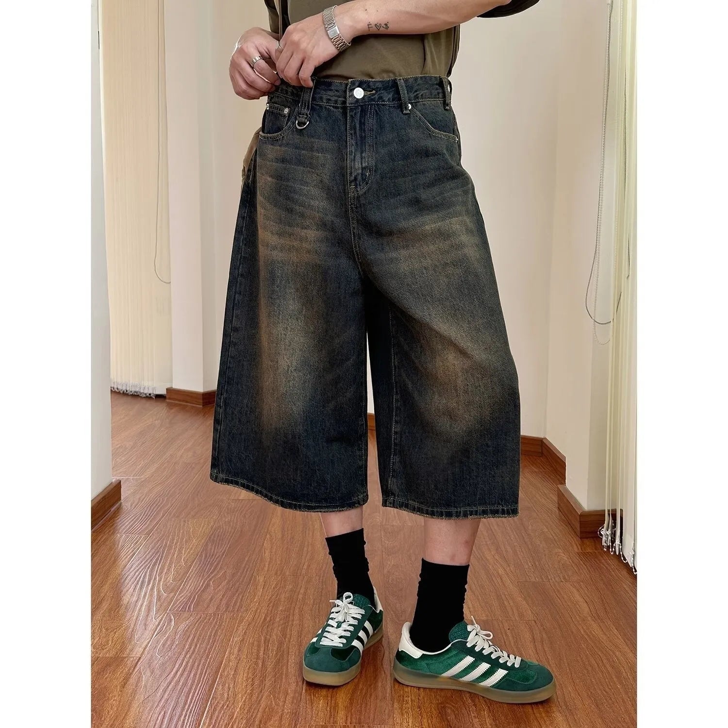 Men's loose straight-leg denim shorts in blue on a plain background