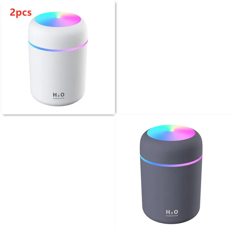 Pink USB desktop humidifier with colourful LED lights and 300ml water tank on wooden desk