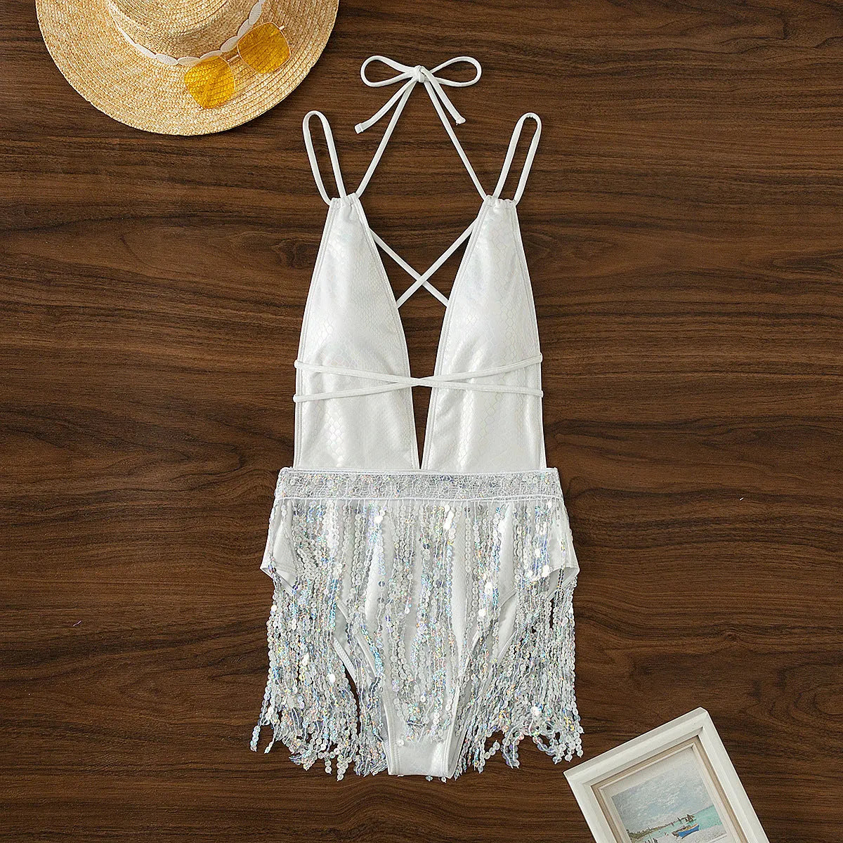 White deep V-neck one-piece swimsuit with tassel detailing and dress-style silhouette