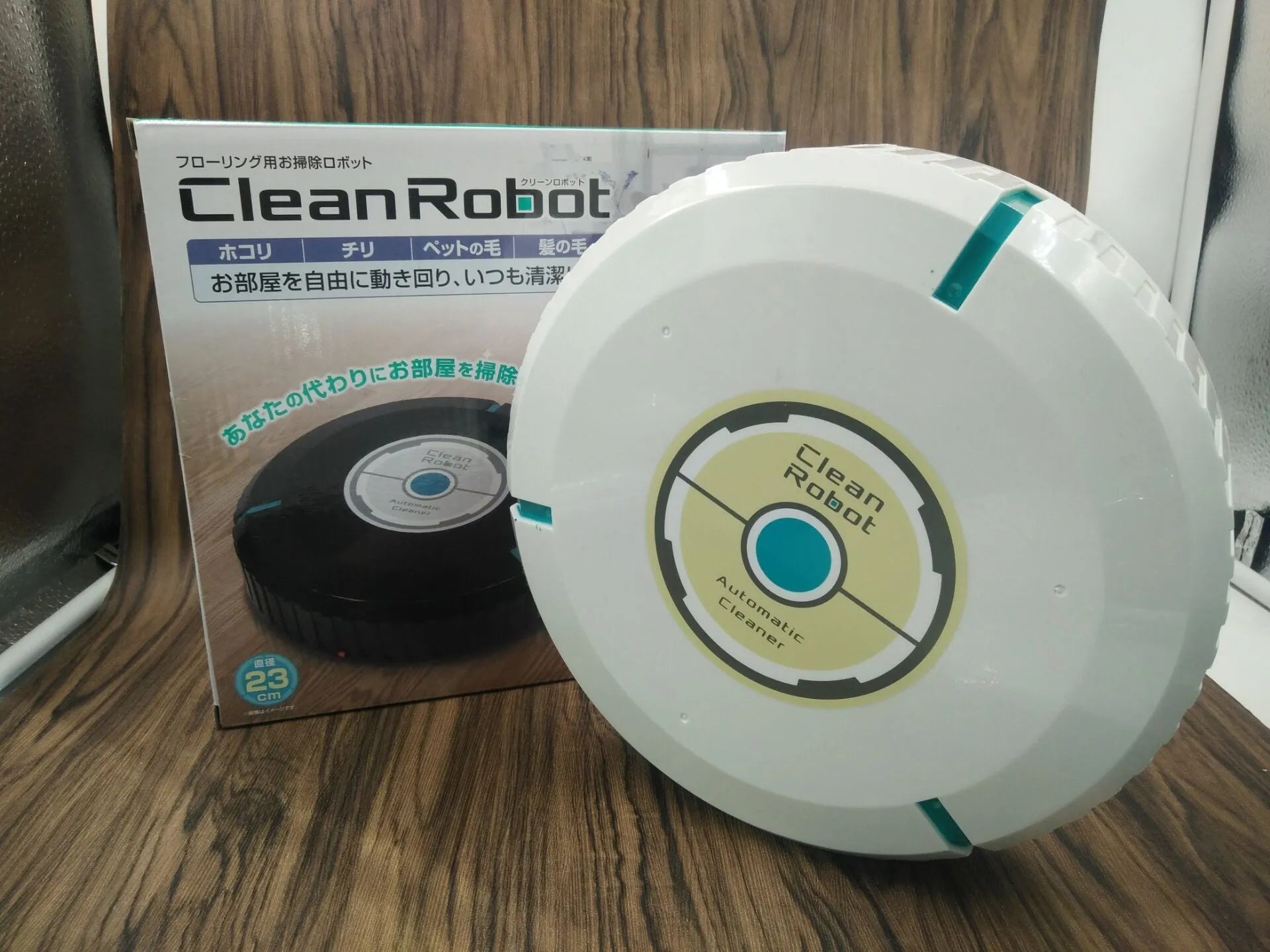 Black or white ABS plastic robot vacuum cleaner on a hardwood floor.