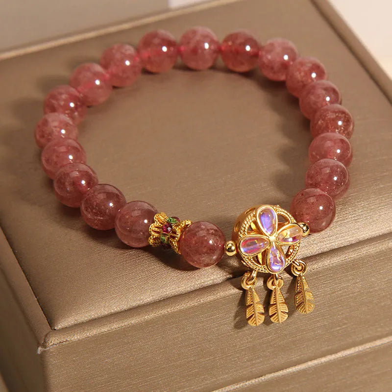 Women's bracelet with strawberry quartz dream catcher pendant on wrist