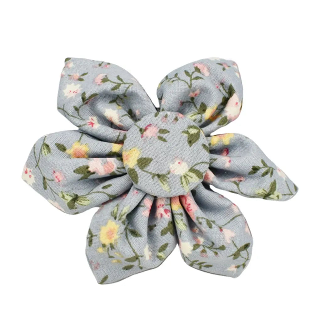 Blue floral patterned cloth dog collar and leash set with matching vest and bow accessories.