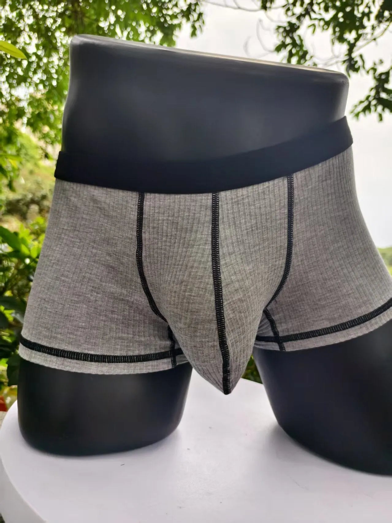 Men's solid colour breathable fibre boxer shorts shown in army green, demonstrating thin fabric and fit.