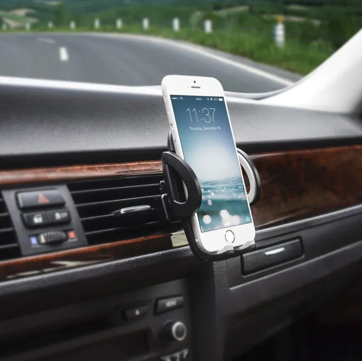 Black universal mobile phone holder attached to a car air conditioning vent.