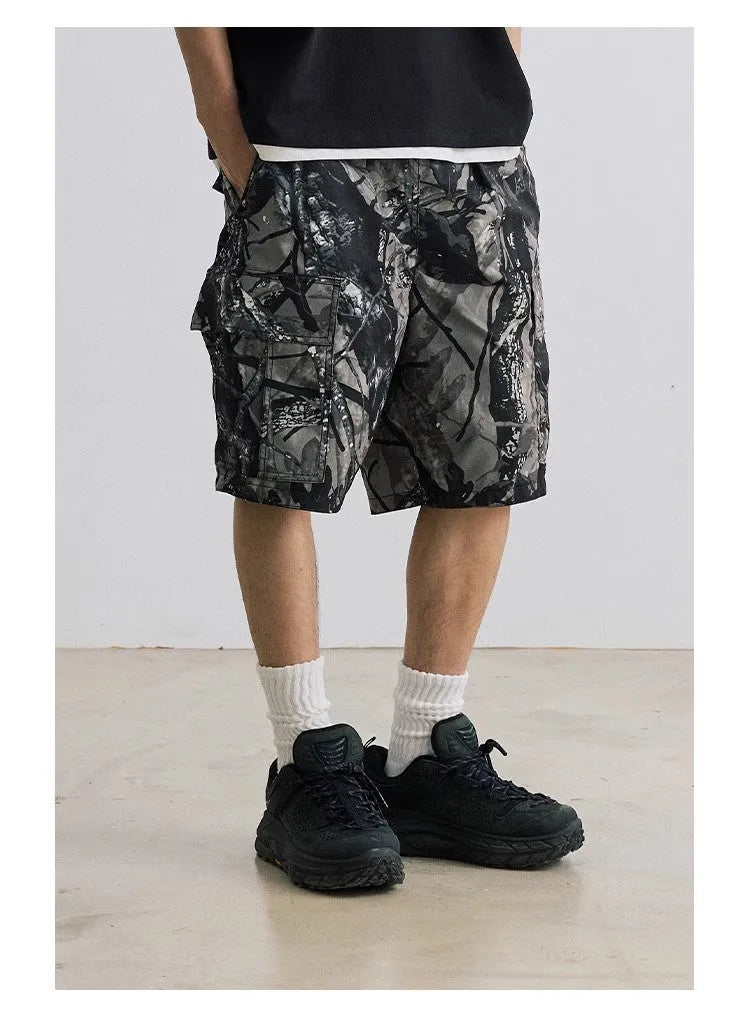 Man wearing loose straight-leg denim shorts in army green, showing mid waist and casual style.