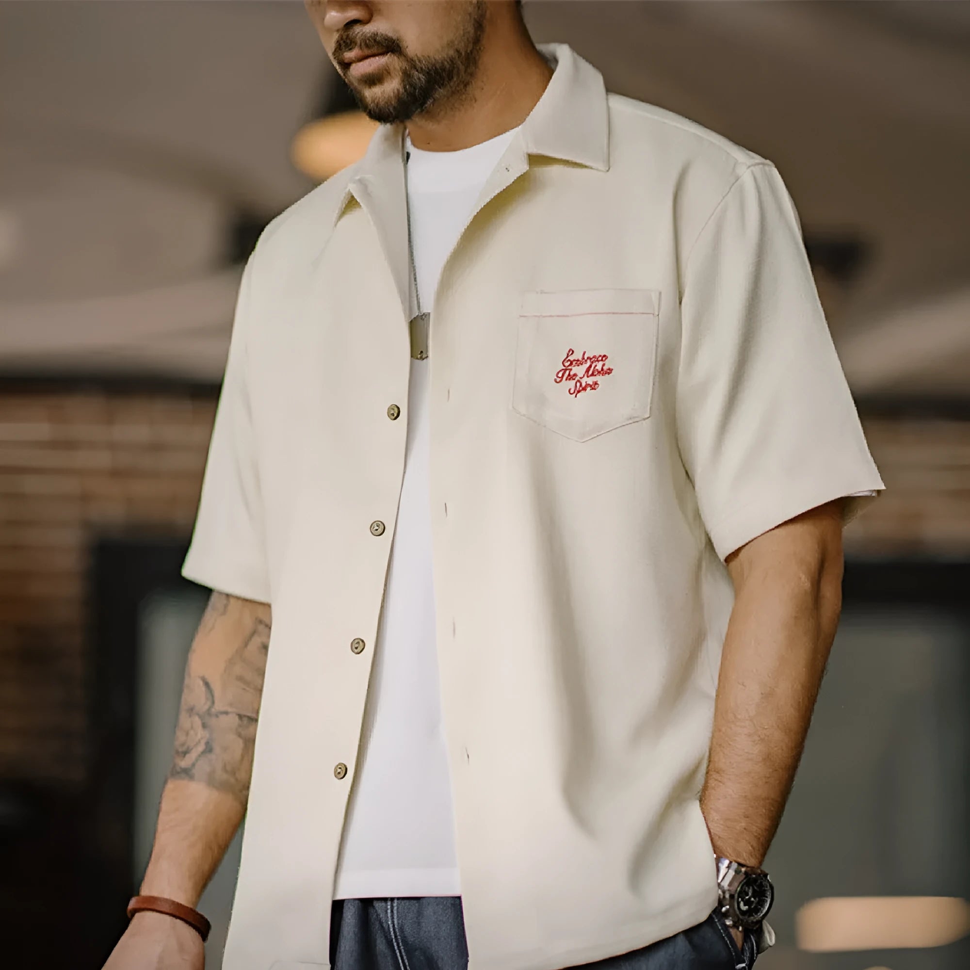 Light apricot men's shirt with bamboo and flower pattern and a Cuban collar.