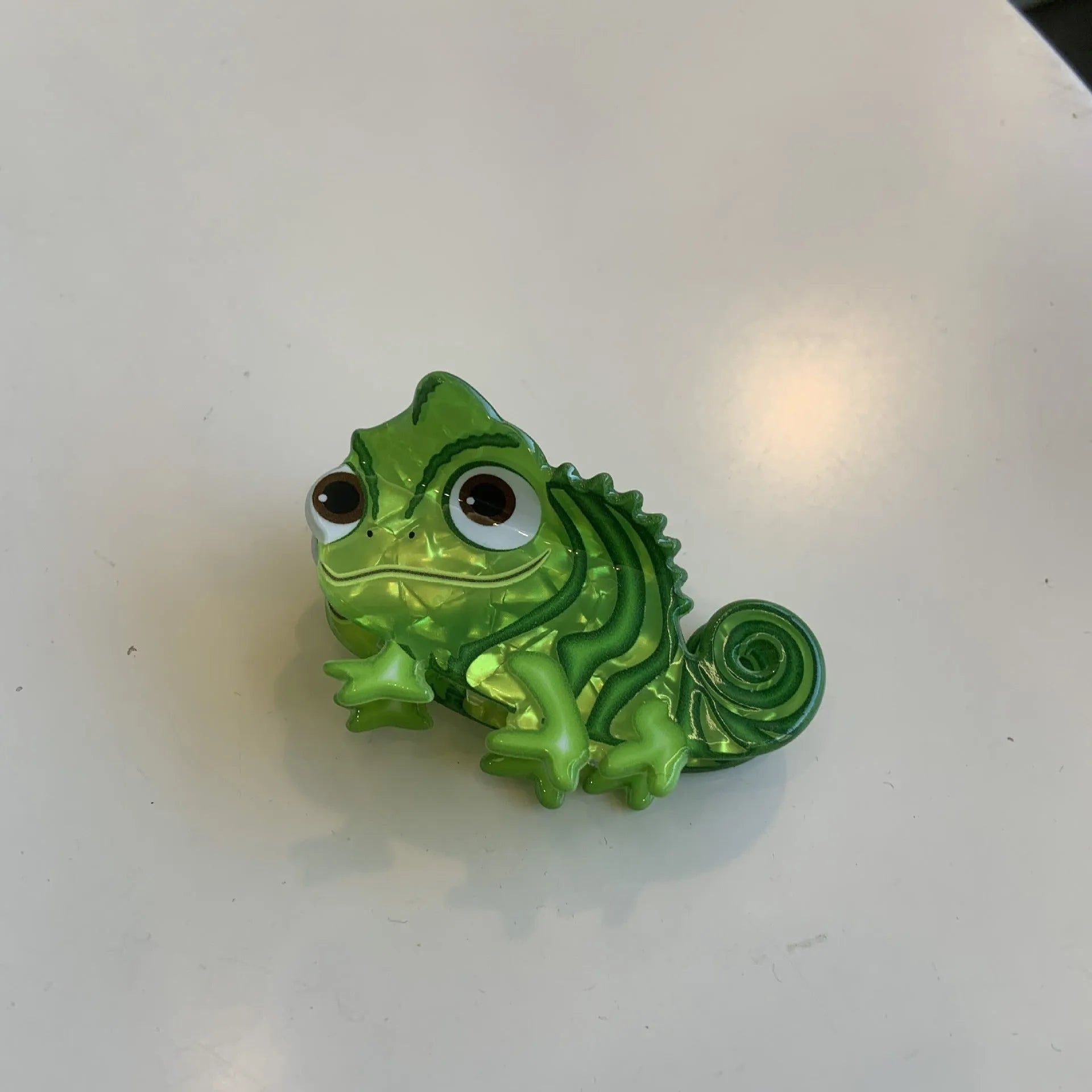 Acrylic hair clip with dinosaur design in various colours including blue, brown, green, pink and purple variants